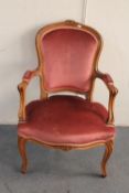 A carved beech framed salon armchair in pink dralon