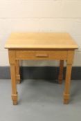 An oak side table fitted a drawer,