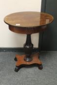 A continental mahogany oval pedestal work table,