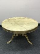 An Italian circular onyx coffee table on an ornate brass base