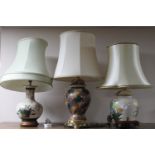 A group of five earthenware table lamps with shades