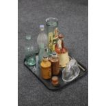 A tray containing antique stoneware and glass bottles, an antique glass jelly mould of a rabbit,
