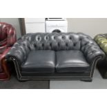 A blue buttoned leather Chesterfield style settee
