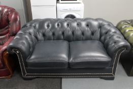 A blue buttoned leather Chesterfield style settee