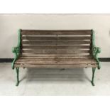 A cast iron and wooden slatted garden bench