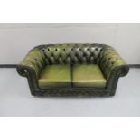 A green buttoned leather Chesterfield style two seater settee