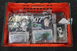 A crate of James Bond Collection cars and magazines