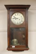 A beech wall clock with silvered dial,