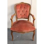 A carved beech framed salon armchair in pink dralon