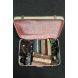 A suitcase containing Minolta camera and lenses, antiquarian and later books,