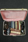 A suitcase containing Minolta camera and lenses, antiquarian and later books,