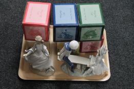 A Lladro figure of a lady in dress, a Lladro figure of children on a seesaw,