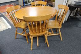 A contemporary oak circular dining table and four chairs