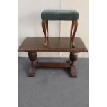 A heavily carved oak refectory coffee table and a dressing table stool