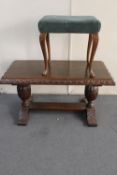 A heavily carved oak refectory coffee table and a dressing table stool