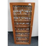 A display case containing a large quantity of crested teaspoons