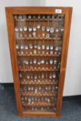 A display case containing a large quantity of crested teaspoons