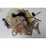 A bag of costume jewellery, lady's wristwatches, simulated pearls,