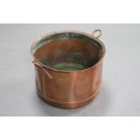 An antique copper twin handled cooking pot