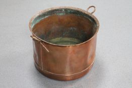 An antique copper twin handled cooking pot