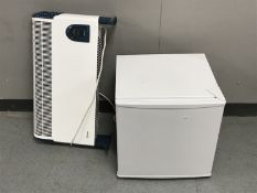 A bench top fridge and a Dimplex electric panel heater