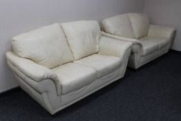 A pair of cream leather two seater settees