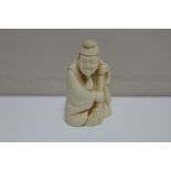 A resin netsuke - elderly gentleman with brush