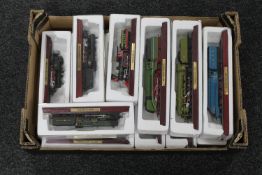 A box of twenty-three die cast model trains on wooden plinths