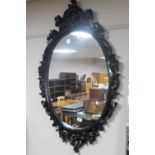 A wooden framed Rococo style mirror