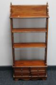 A set of reproduction fretwork open bookshelves fitted four drawers
