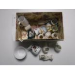 A box containing assorted tourist china and a china dolly top