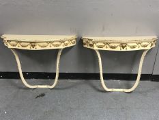 A pair of cream and gilt wall mounted hall tables