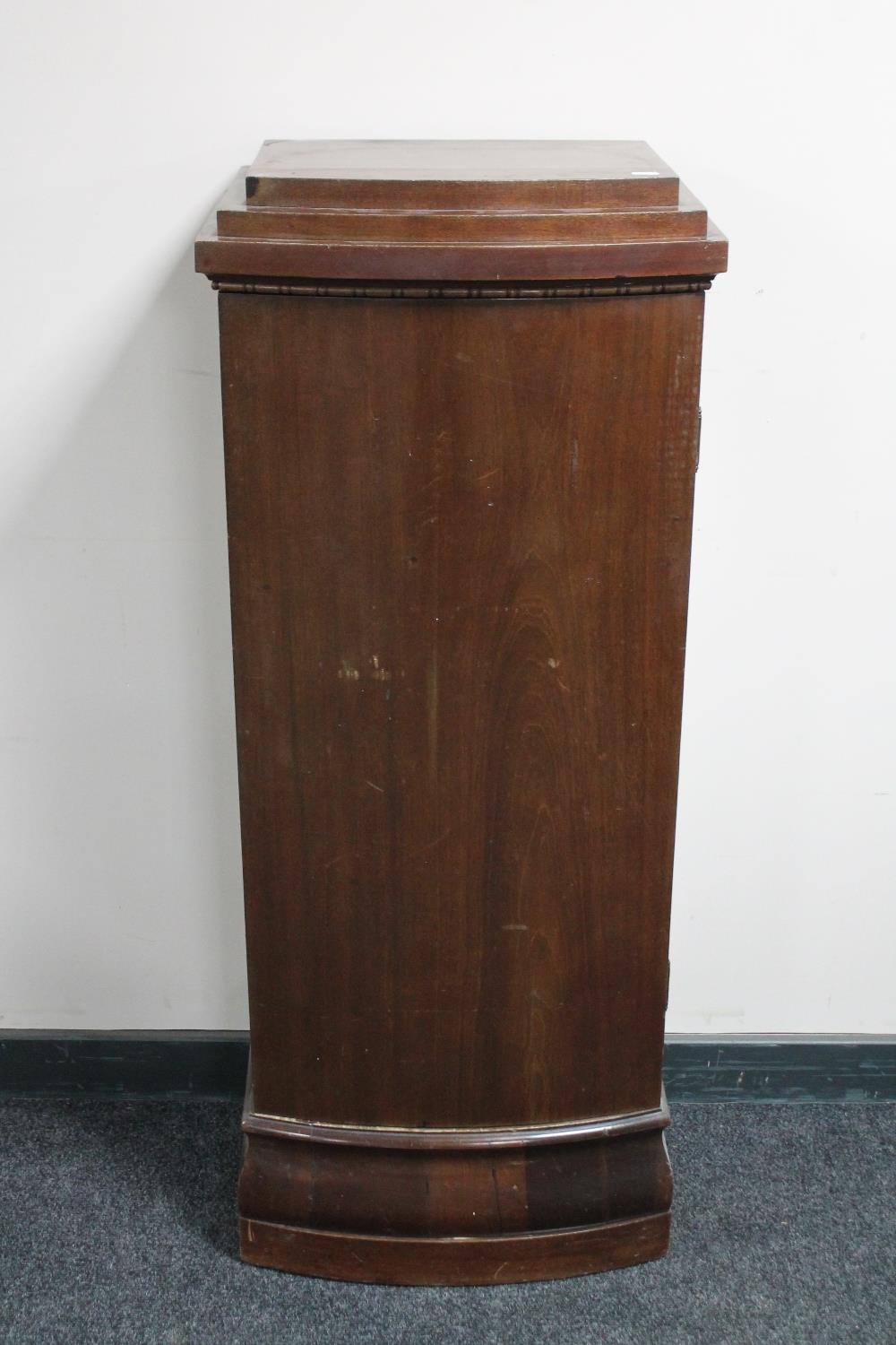 An antique mahogany sentry door cabinet