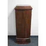 An antique mahogany sentry door cabinet