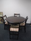 A pedestal dining table and four chairs