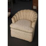 A tub chair in cream fabric