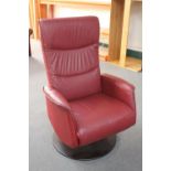 A late 20th century red leather high back armchair on metal base