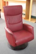 A late 20th century red leather high back armchair on metal base