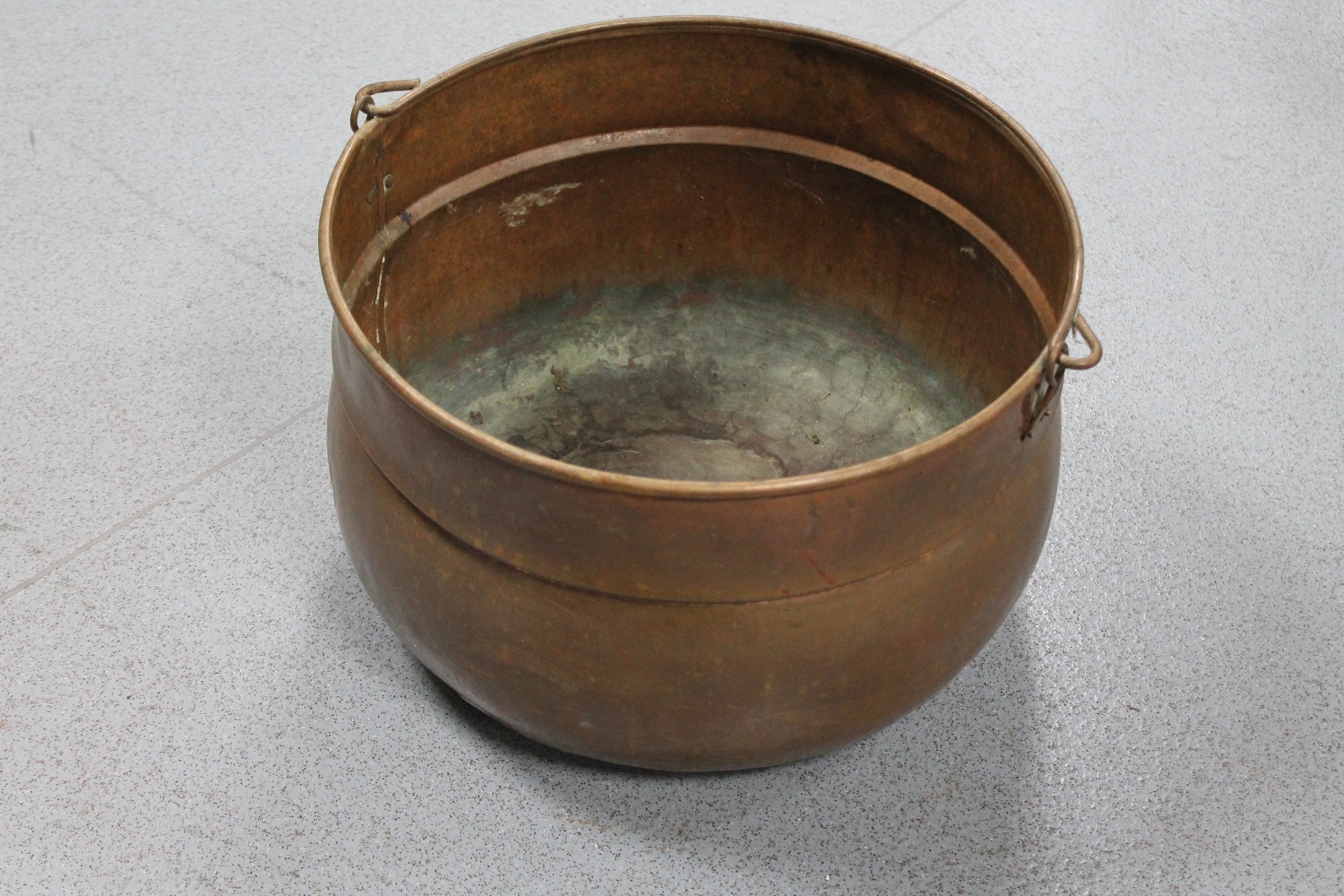 An antique copper swing handled cooking pot