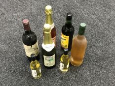 A tray of seven bottles of alcohol including Cider, Chardonnay,