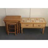 A nest of three blonde oak tables and a tiled topped low table