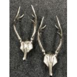 Two cast metal antler coat hooks