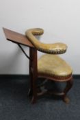 An antique leather upholstered cock fighting chair