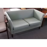 A late 20th century two seater settee in green fabric