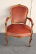 A carved beech framed salon armchair in pink dralon