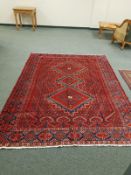 A Persian carpet on red ground,