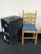 A metal bound trunk and a pine ladder back dining chair