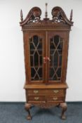 A reproduction Chippendale style display cabinet on claw and ball feet