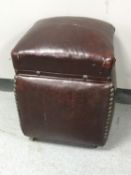 An early 20th century leather upholstered storage stool
