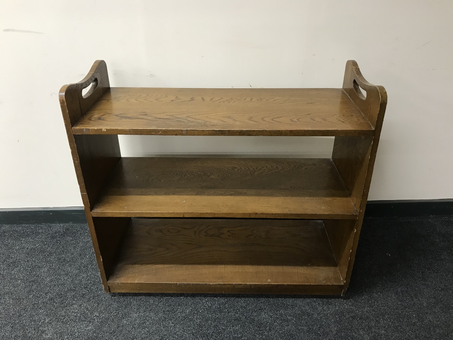 An oak three tier book trolley